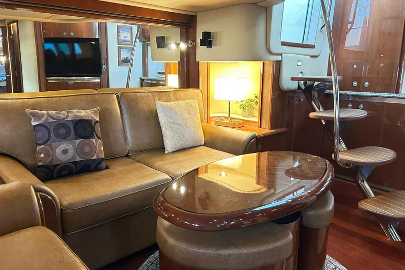 Rock It Yacht Photos Pics Luxurious interior of a 2007 Sea Ray 52 Sundancer yacht with elegant seating and wooden accents.