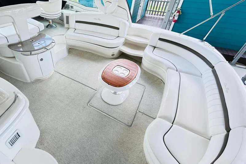 Rock It Yacht Photos Pics Luxurious 2007 Sea Ray 52 Sundancer yacht interior with elegant white seating and wooden table.