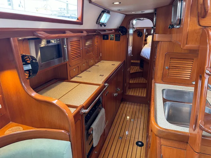 Shearwater Yacht Photos Pics Interior of 2008 Hylas 46 yacht with wooden cabinetry and modern kitchen amenities.