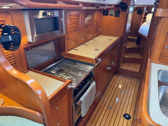 Shearwater Yacht Photos Pics Luxurious 2008 Hylas 46 yacht interior with wooden cabinetry and modern kitchen amenities.