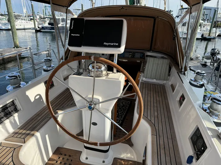 Shearwater Yacht Photos Pics Cockpit of 2008 Hylas 46 sailboat with wooden steering wheel and navigation equipment.