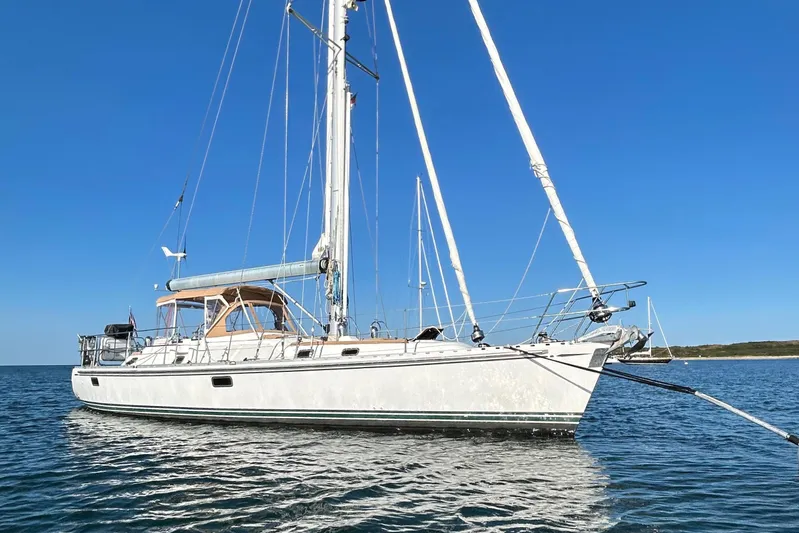 Shearwater Yacht Photos Pics Sailing yacht Hylas 46, 2008 model, anchored on calm water under clear blue sky.