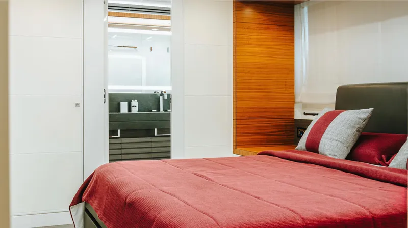 Yacht Photos Pics Luxurious bedroom interior on 2017 Astondoa 100 Century yacht, featuring modern design and red bedding.