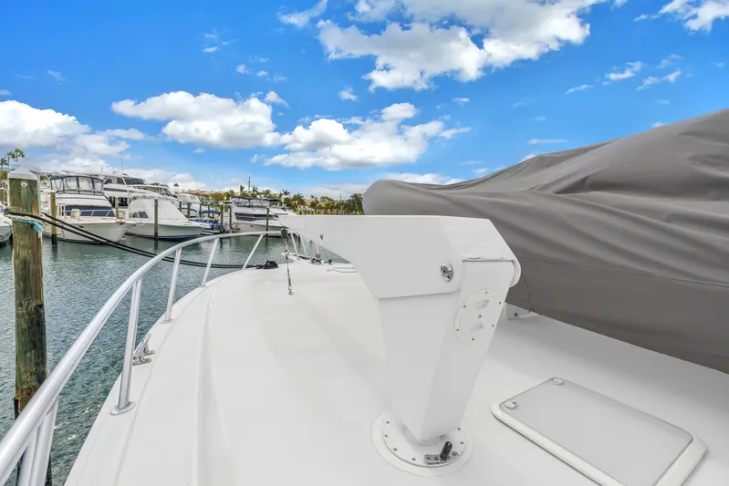 Reel Blonde Yacht Photos Pics 1999 Viking 72 Enclosed Bridge yacht docked at marina under blue sky.