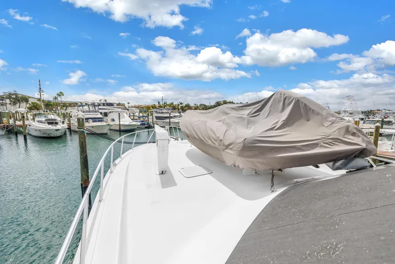 Reel Blonde Yacht Photos Pics 1999 Viking 72 Enclosed Bridge yacht docked at marina under blue sky.