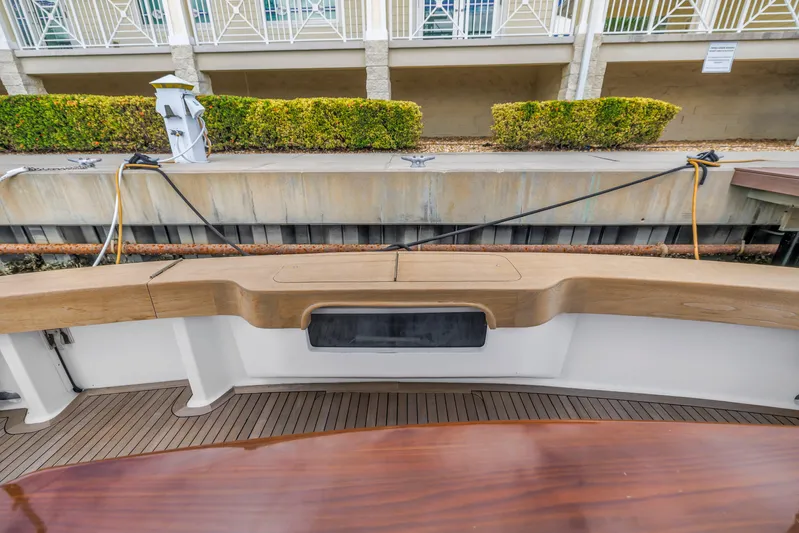 Reel Blonde Yacht Photos Pics 1999 Viking 72 Enclosed Bridge yacht docked, featuring teak deck and seating area.