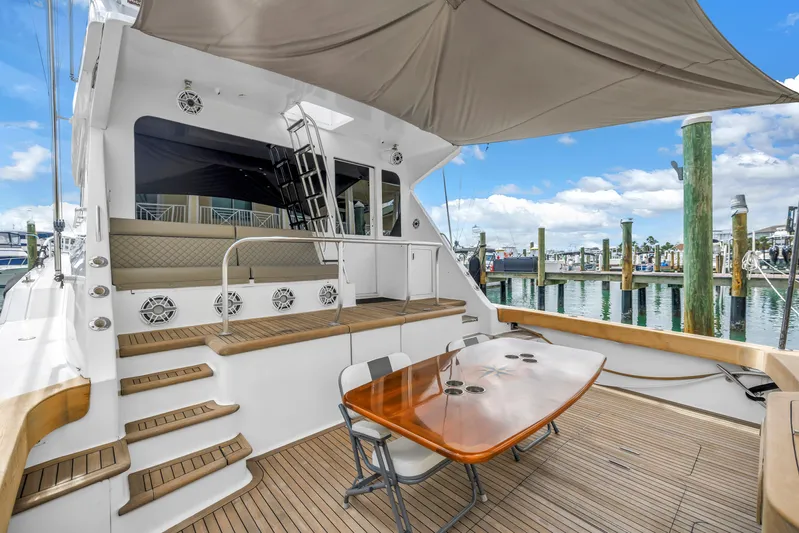 Reel Blonde Yacht Photos Pics 1999 Viking 72 Enclosed Bridge yacht with teak deck and outdoor seating at marina.