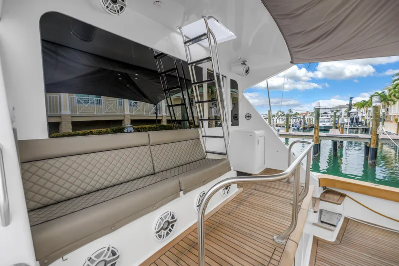 Reel Blonde Yacht Photos Pics 1999 Viking 72 Enclosed Bridge yacht with elegant seating and marina view.