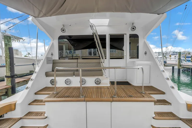 Reel Blonde Yacht Photos Pics 1999 Viking 72 Enclosed Bridge yacht with spacious deck and seating area at marina.