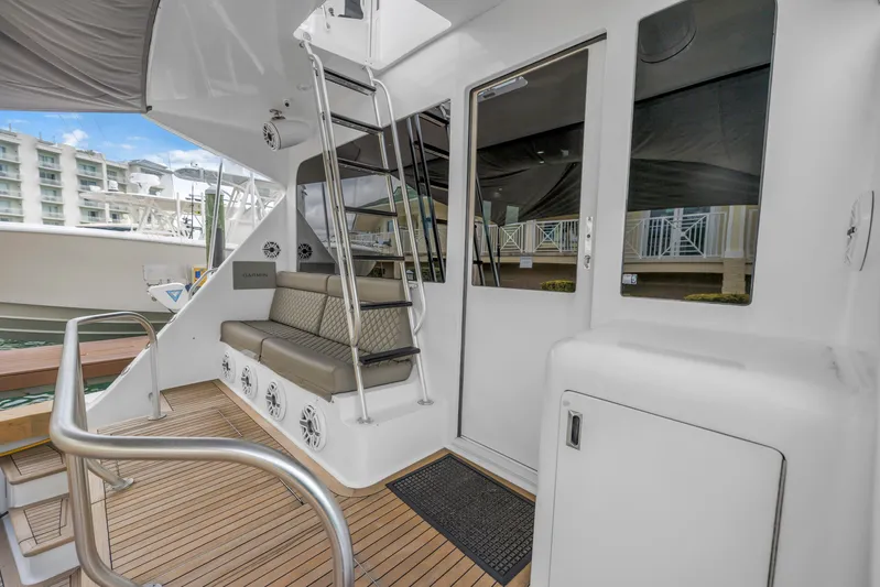 Reel Blonde Yacht Photos Pics 1999 Viking 72 Enclosed Bridge yacht with seating, ladder, and teak deck.