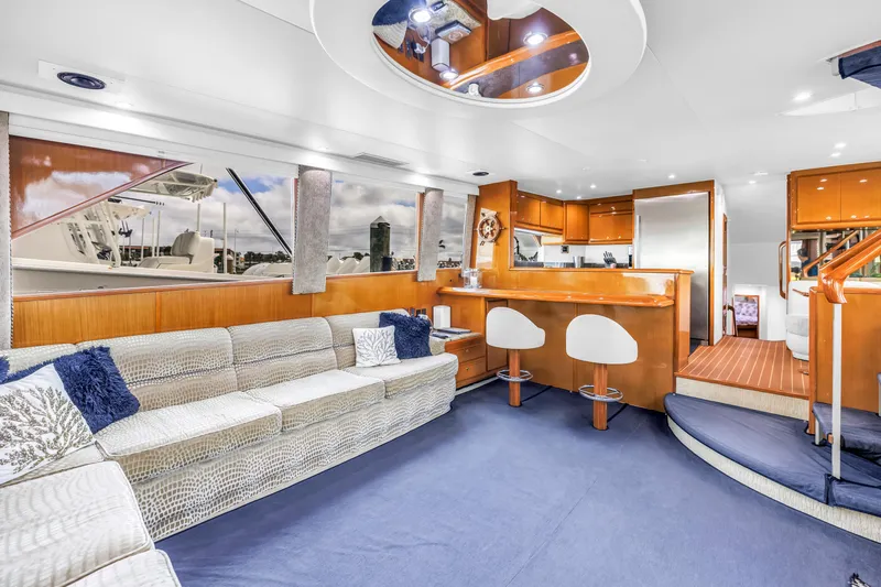 Reel Blonde Yacht Photos Pics Luxurious interior of 1999 Viking 72 Enclosed Bridge yacht with modern furnishings and elegant design.