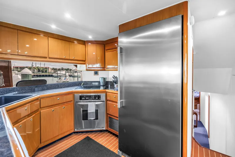 Reel Blonde Yacht Photos Pics Luxurious kitchen interior of 1999 Viking 72 Enclosed Bridge yacht with modern appliances.