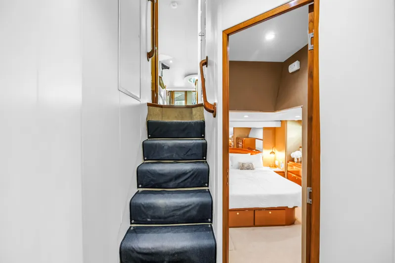 Reel Blonde Yacht Photos Pics Staircase and bedroom interior of 1999 Viking 72 Enclosed Bridge yacht.