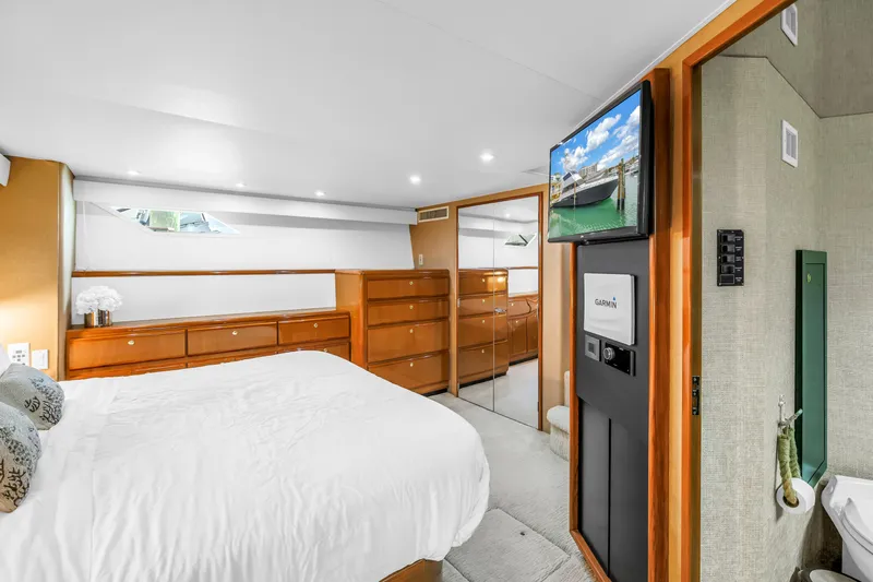 Reel Blonde Yacht Photos Pics Luxurious bedroom interior of 1999 Viking 72 Enclosed Bridge yacht with modern amenities.