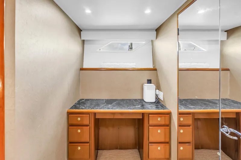 Reel Blonde Yacht Photos Pics Luxurious interior of 1999 Viking 72 Enclosed Bridge yacht with elegant wood cabinetry.