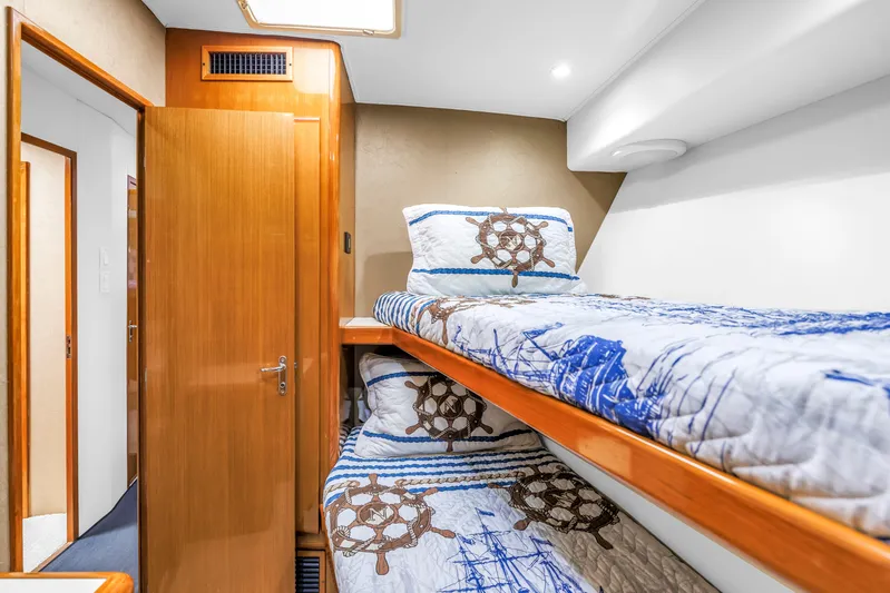 Reel Blonde Yacht Photos Pics Cozy cabin with nautical-themed bunk beds on 1999 Viking 72 Enclosed Bridge yacht.