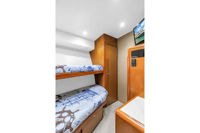 Reel Blonde Yacht Photos Pics 1999 Viking 72 Enclosed Bridge cabin with bunk beds and nautical-themed decor.