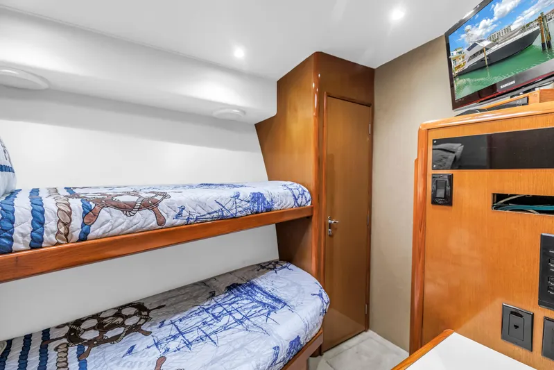 Reel Blonde Yacht Photos Pics Interior of 1999 Viking 72 Enclosed Bridge with bunk beds and nautical decor.