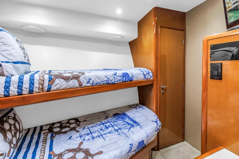 Reel Blonde Yacht Photos Pics Bunk beds in 1999 Viking 72 Enclosed Bridge yacht cabin with nautical-themed bedding.