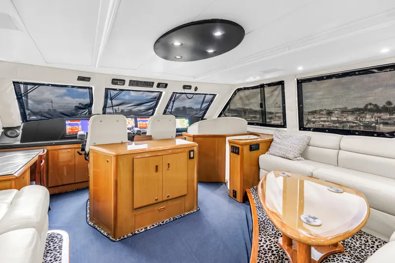 Reel Blonde Yacht Photos Pics Luxurious interior of 1999 Viking 72 Enclosed Bridge yacht with modern helm and seating.