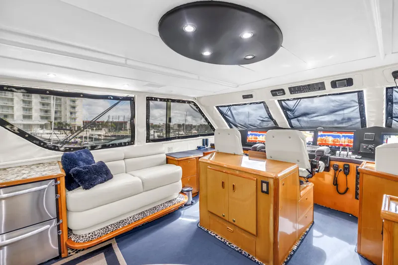 Reel Blonde Yacht Photos Pics Luxurious interior of 1999 Viking 72 Enclosed Bridge yacht with modern helm and seating.