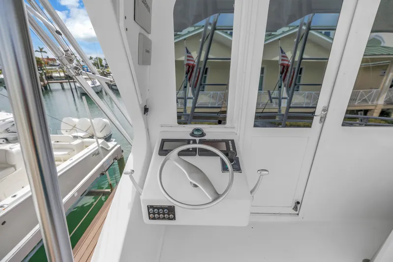 Reel Blonde Yacht Photos Pics 1999 Viking 72 Enclosed Bridge yacht helm with steering wheel and control panel.