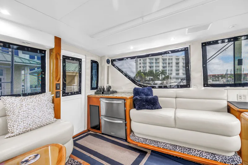 Reel Blonde Yacht Photos Pics Luxurious interior of 1999 Viking 72 Enclosed Bridge yacht with plush seating and modern decor.