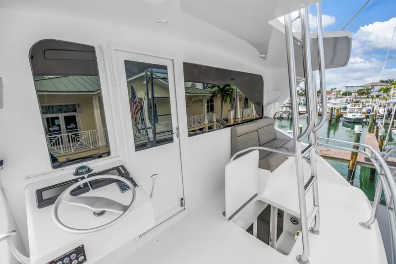 Reel Blonde Yacht Photos Pics 1999 Viking 72 Enclosed Bridge yacht interior with helm, seating, and marina view.