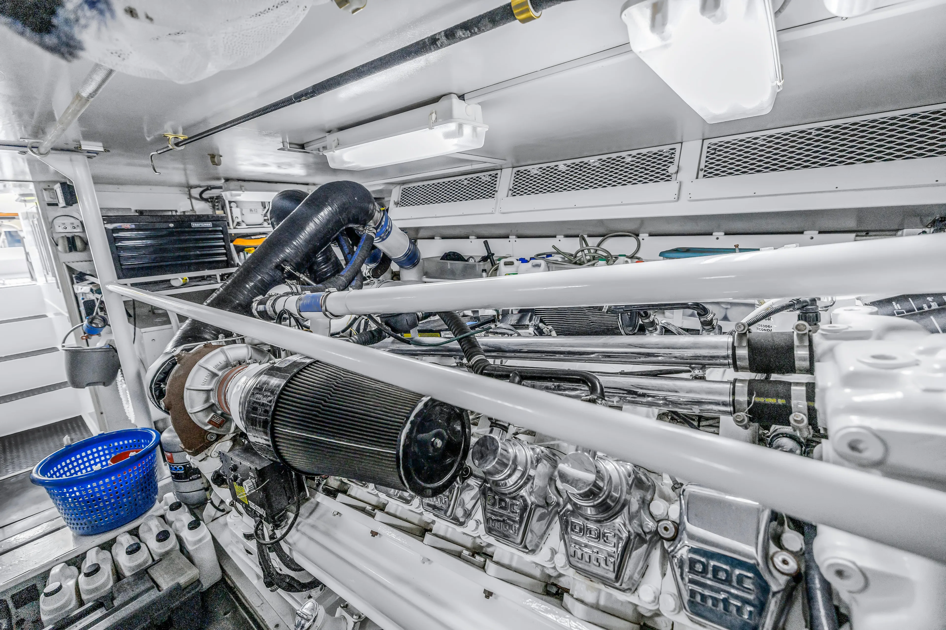 Reel Blonde Yacht Photos Pics Engine room of a 1999 Viking 72 Enclosed Bridge yacht, showcasing mechanical components.