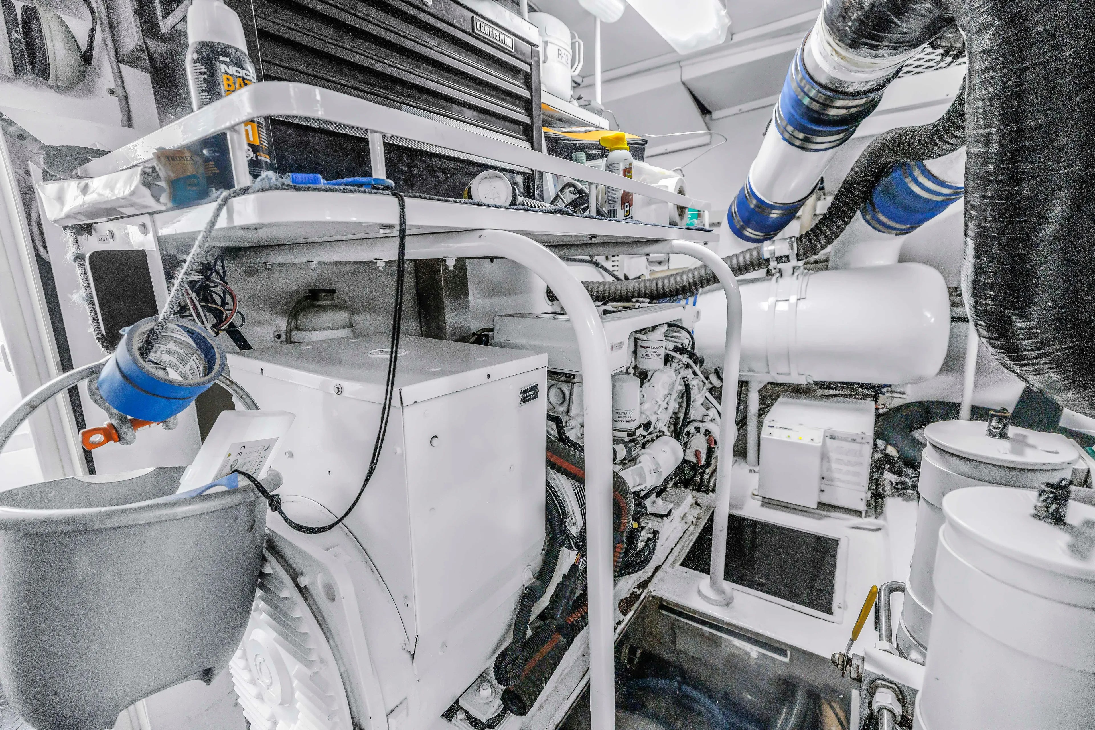 Reel Blonde Yacht Photos Pics Engine room of 1999 Viking 72 Enclosed Bridge yacht, showcasing machinery and equipment.