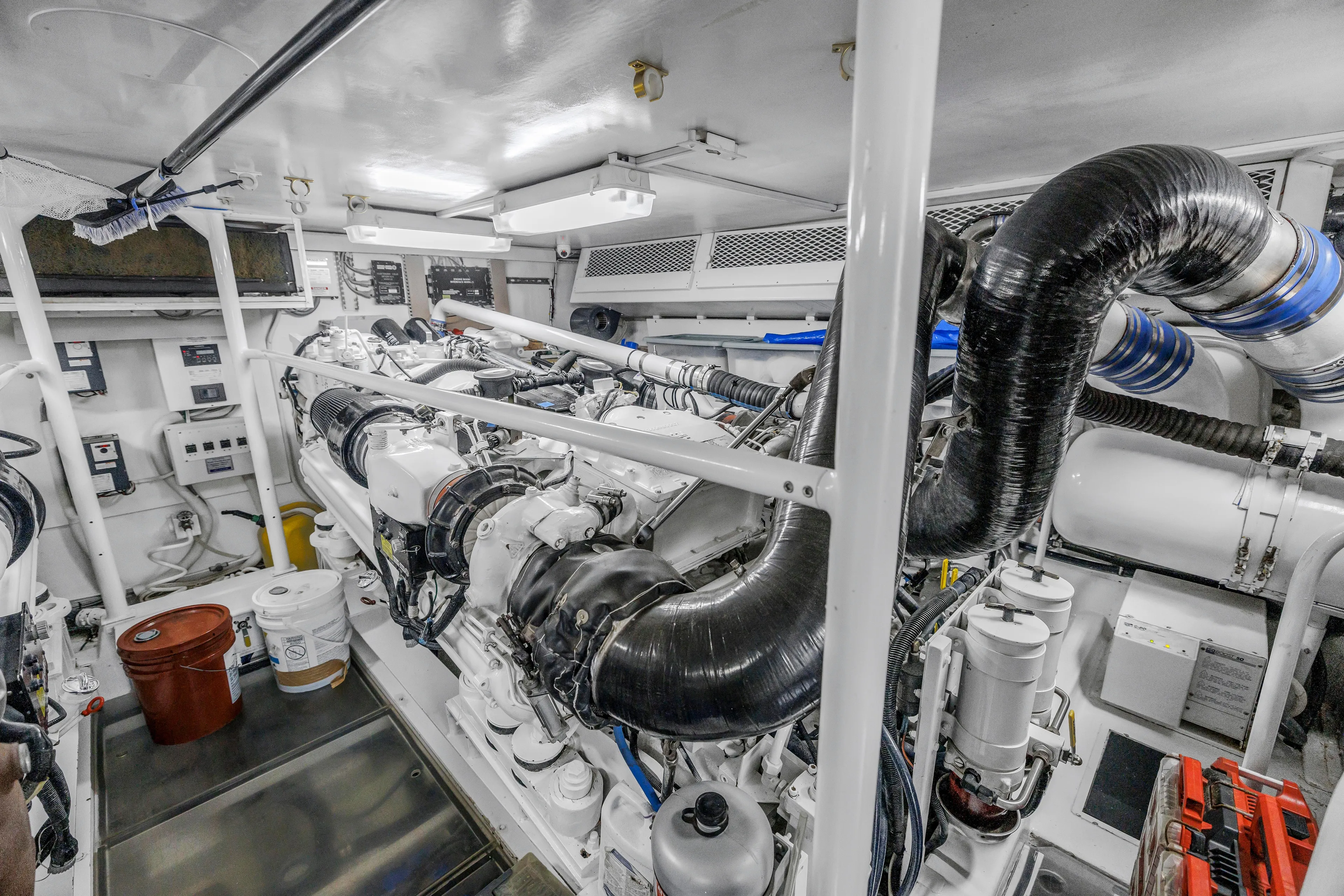 Reel Blonde Yacht Photos Pics Engine room of 1999 Viking 72 Enclosed Bridge yacht, showcasing complex machinery and equipment.