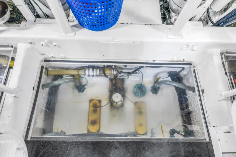 Reel Blonde Yacht Photos Pics Engine room of 1999 Viking 72 Enclosed Bridge yacht, showcasing mechanical components.