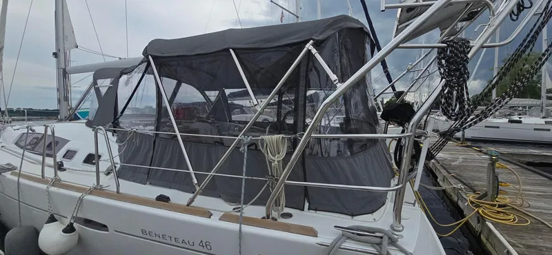 Diamant Noir Yacht Photos Pics Beneteau Oceanis 46 sailboat, 2011 model, docked with protective canopy and visible rigging.