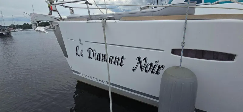 Diamant Noir Yacht Photos Pics Beneteau Oceanis 46 sailboat named "Le Diamant Noir" docked in a marina, 2011 model.