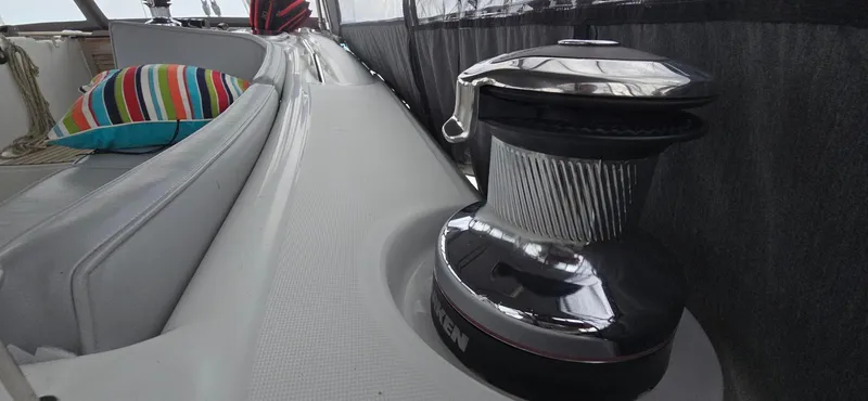 Diamant Noir Yacht Photos Pics Beneteau Oceanis 46 yacht deck with winch and colorful cushion, 2011 model.