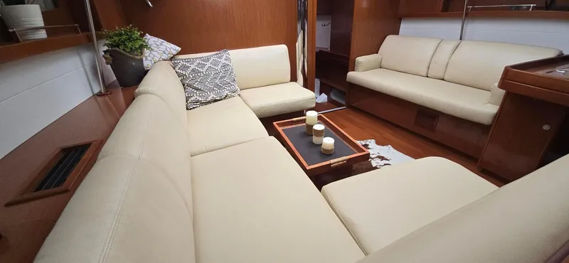 Diamant Noir Yacht Photos Pics Luxurious interior of 2011 Beneteau Oceanis 46 yacht with cream sofas and wooden accents.