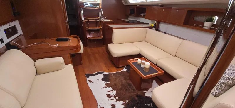 Diamant Noir Yacht Photos Pics Luxurious interior of 2011 Beneteau Oceanis 46 yacht with beige seating and wooden accents.
