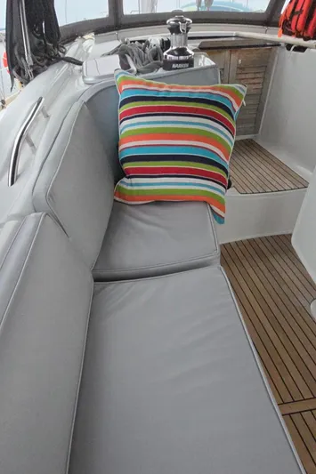 Diamant Noir Yacht Photos Pics Beneteau Oceanis 46 yacht interior with striped cushion, teak flooring, and sleek seating, 2011 model.