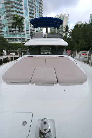  Yacht Photos Pics 2014 Azimut Magellano 43 yacht with sunbathing area, docked near modern buildings.