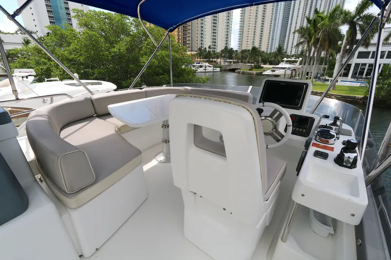 Yacht Photos Pics 2014 Azimut Magellano 43 yacht helm with seating, controls, and waterfront view.