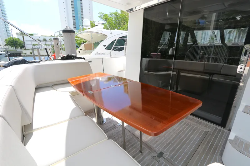  Yacht Photos Pics Luxurious 2014 Azimut Magellano 43 yacht with elegant outdoor seating and polished wooden table.