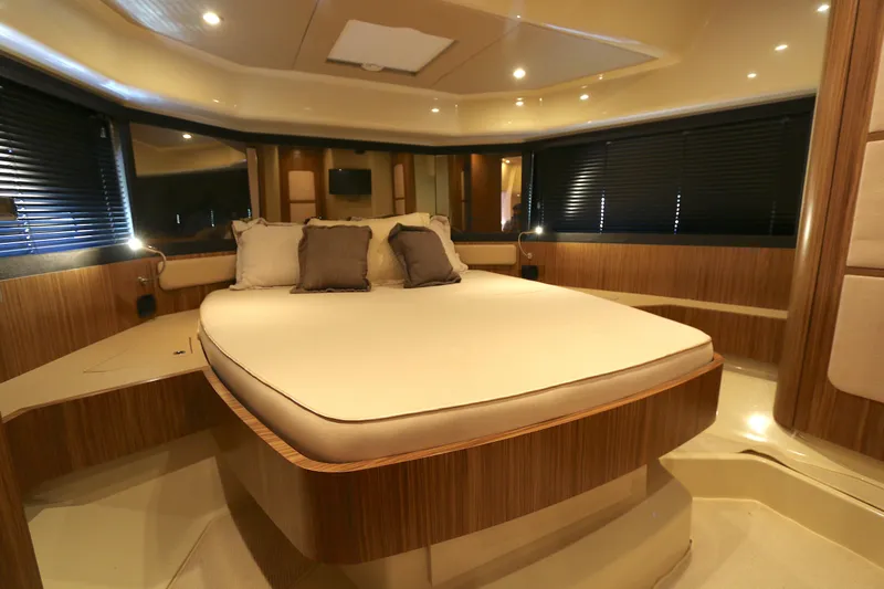 Yacht Photos Pics Luxurious bedroom interior of 2014 Azimut Magellano 43 yacht with elegant wood finishes.