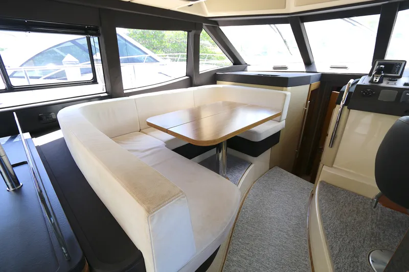  Yacht Photos Pics Interior of 2014 Azimut Magellano 43 yacht with elegant dining area and panoramic windows.