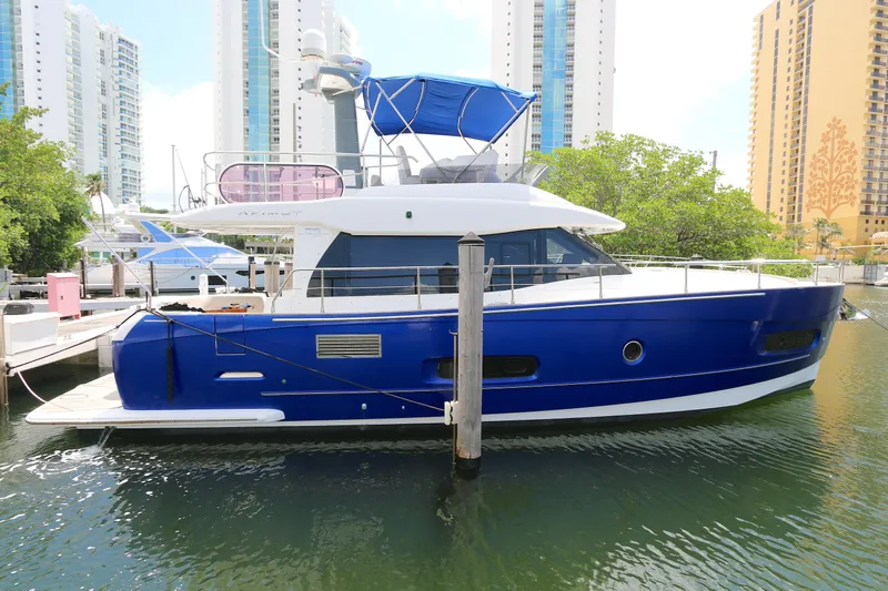  Yacht Photos Pics 2014 Azimut Magellano 43 yacht docked in a marina, surrounded by tall buildings.
