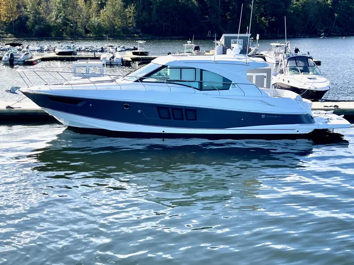 Salacia Yacht Photos Pics 2018 Cruisers 45 Cantius yacht docked on a serene lake with surrounding boats.