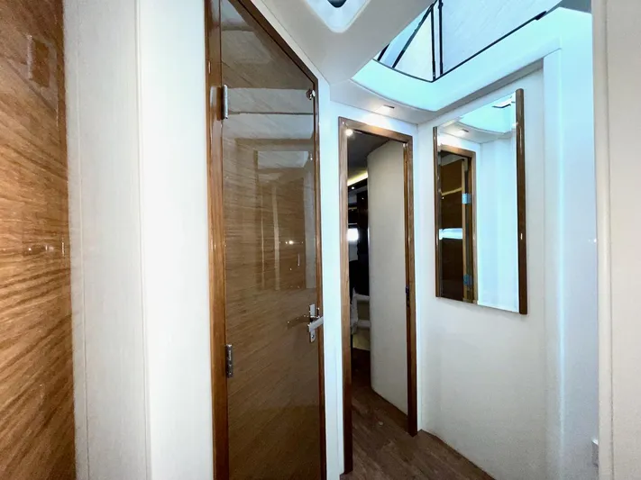 Salacia Yacht Photos Pics Interior hallway of 2018 Cruisers 45 Cantius yacht with wooden doors and skylight.
