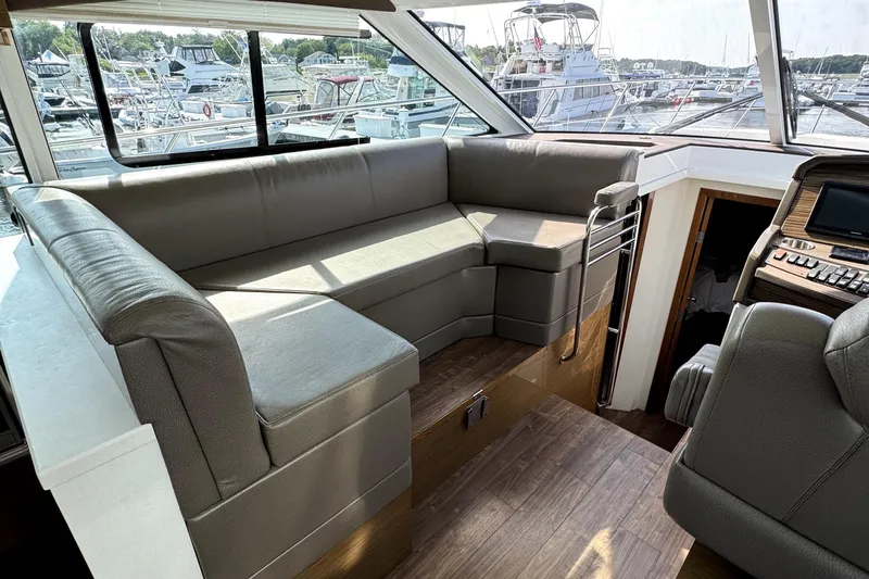 Salacia Yacht Photos Pics Interior of 2018 Cruisers Yachts 45 Cantius with plush seating and marina view.