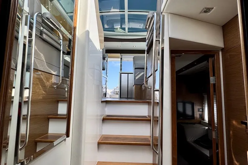 Salacia Yacht Photos Pics Interior view of 2018 Cruisers Yachts 45 Cantius, featuring wooden stairs and modern design.
