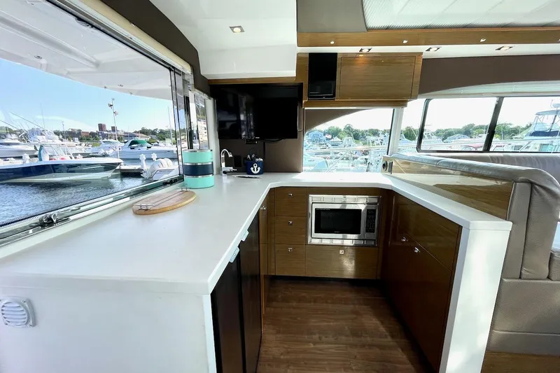 Salacia Yacht Photos Pics Luxurious 2018 Cruisers Yachts 45 Cantius interior kitchen with modern appliances and marina view.