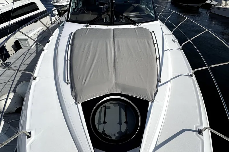 Salacia Yacht Photos Pics 2018 Cruisers Yachts 45 Cantius deck with sunpad and hatch, docked at marina.